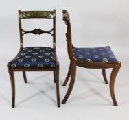 A set of four Regency rosewood and brass inlaid dining chairs, with central lozenge carved spar