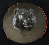 A Japanese bronze roundel, early 20th century, cast in high relief with a tiger`s head, unsigned,