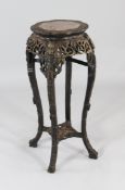 A late 19th century Chinese rosewood jardiniere stand, with inset shaped marble top above a