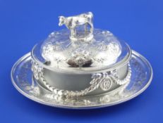 A Victorian silver circular butter dish and cover, with frosted glass liner, the base with embossed