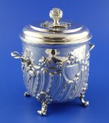 A late Victorian repousse silver two handled biscuit box by Charles Stuart Harris, with demi-spiral