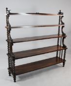 A Victorian rosewood waterfall bookcase, with barley twist turned uprights and carved acanthus C