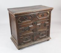 A late 17th century oak chest, of three long drawers, with geometric moulded fronts, later brass