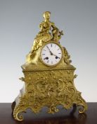 A 19th century French ormolu mantel clock, surmounted with a figure of a seated lady holding a fan,