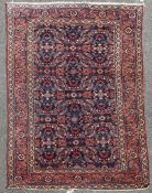 A 1920`s North West Persian Tabriz rug, with geometric field of scrolling foliage, on a deep blue