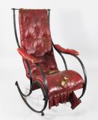 A Victorian steel rocking chair, after a design by R.W. Winfield, with distressed red leather