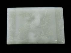 A Chinese pale celadon jade rectangular belt buckle, 18th / 19th century, finely carved in relief