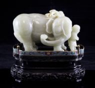 A Chinese celadon and pale russet jade group of an elephant led by a man, the elephant standing