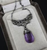 An early 20th century Scottish? Arts and Crafts silver and amethyst drop pendant, of pierced scroll