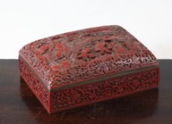 A Chinese cinnabar lacquer domed top rectangular box, early 20th century, the cover carved in high