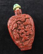 A Chinese cinnabar lacquer snuff bottle, 1780-1880, of flattened pear form, carved in high relief
