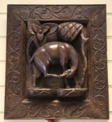 An Indian relief carved hardwood panel, depicting a cow by trees, 18 x 16in.