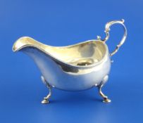 A George III Irish silver sauceboat by Matthew West, with beaded rim and acanthus leaf capped
