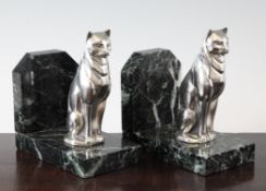 A pair of Art Deco silvered spelter bookends, modelled as seated cats, with green marble bases, 5.