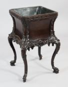 A Chippendale revival mahogany jardiniere, lead lined, with blind fret carved border, rocaille and