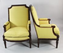 A pair of Louis XVI style carved mahogany high back armchairs, with yellow patterned upholstery,