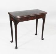 A George III mahogany folding card table, on tapering pole legs and pad feet, W.2ft 10in.
