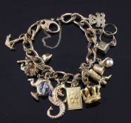 A 9ct gold curb link charm bracelet, hung with seventeen charms, gross weight 28 grams.