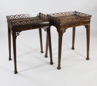 A pair of George III style mahogany silver tables, the rectangular tops with pierced fret work