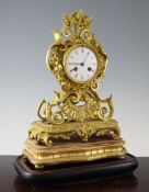 A 19th century French ormolu mantel clock, in symmetrical scroll case with enamelled dial and