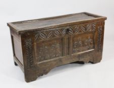 A 17th / 18th century carved oak coffer, twin panel front with lunette carved frieze and floral