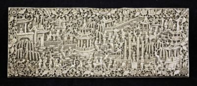 A Chinese export ivory panel, 19th century, carved in high relief with figures amid pagodas,