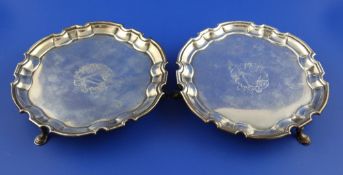 A pair of George II silver waiters by John Tuite, of shaped circular form, with engraved armorials,