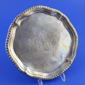 A George II silver waiter, of shaped circular form, with engraved armorial and gadrooned border, on