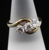 An 18ct gold three stone diamond ring, with scroll shank and three 161 facet cut ""fire"" diamonds,