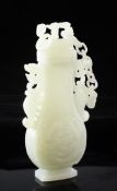 A Chinese celadon-white jade vase, 20th century, of flattened baluster form, carved to each side in