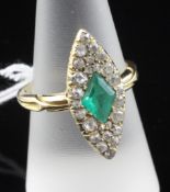 An 18ct gold, emerald and diamond set marquise shaped ring, size Q.