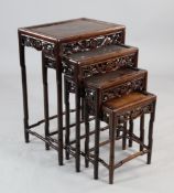 A Chinese rosewood set of four quartetto tables, each frieze carved and pierced with bats, clouds