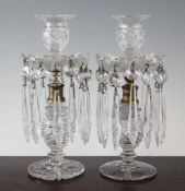 A pair of Regency cut glass and gilt metal mounted table lustre candlesticks, with strawberry cut