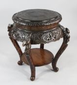 A large Japanese carved hardwood urn stand, Meiji period, decorated all over with fruit, leaves and