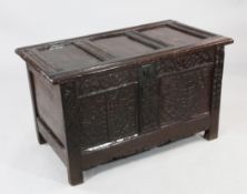 A 17th / 18th century carved oak coffer, the twin panel front with strapwork decoration, W.3ft 2in.