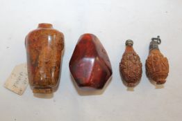 Four Chinese snuff bottles, two made of peach stones, c.1900, each carved in relief with the Eight