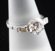 A 1930`s/1940`s platinum and solitaire diamond ring, with baguette cut diamond set shoulders, the