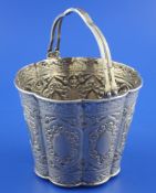 An early 20th century Chinese silver ice bucket, of cusped circular form, embossed with cartouches