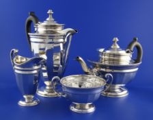 A George V silver four piece tea set, of circular panelled form, Roberts & Belk, Sheffield, 1912/