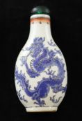 A Chinese porcelain blue enamelled `dragon` snuff bottle, 19th century, enamelled to each side with