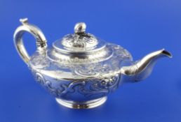 An early Victorian silver teapot, of squat circular form, embossed with foliage and scrolls, Joseph