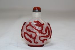A Chinese red overlay glass Chilong glass snuff bottle, 1760-1850, each side carved in high relief