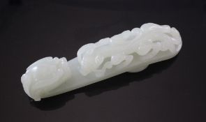 A Chinese pale celadon jade `dragon` belt hook, Qianlong period, carved with an open work chi-