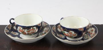 A pair of Worcester blue scale ground coffee cups and saucers, c.1770, in the Kakiemon style,