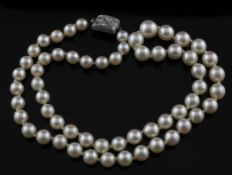 A 1920`s single strand graduated cultured pearl necklace with white gold and diamond set clasp,