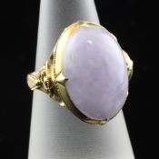 An 18ct gold and oval cabochon lilac jadeite ring, with pierced scroll setting, size M.