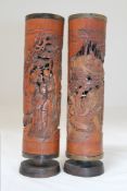 Two Chinese bamboo and horn jostick holders, late 19th/early 20th century, both carved in high