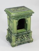 A late 19th century green stoneware stove, with pierced top and sides and arched centre, W.1ft 3in.