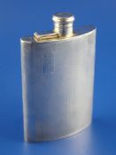 A 1960`s engine turned silver hip flask, of concave form, with engraved initials, F.Burton Crosbee,