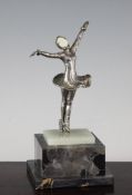An Art Deco silvered bronze and ivory figure of a lady ice skater, on green onyx stepped marble